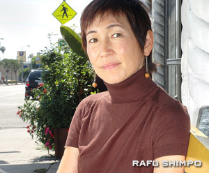 Tanaka, Izumi Emmy nominee Izumi Tanaka reclines in front of a restaurant on Santa Monica Blvd. “I know the power of media, and I would like to utilize it in a way that gives a positive impact to our world,” said the filmmaker. (Mikey Hirano Culross/Rafu Shimpo)